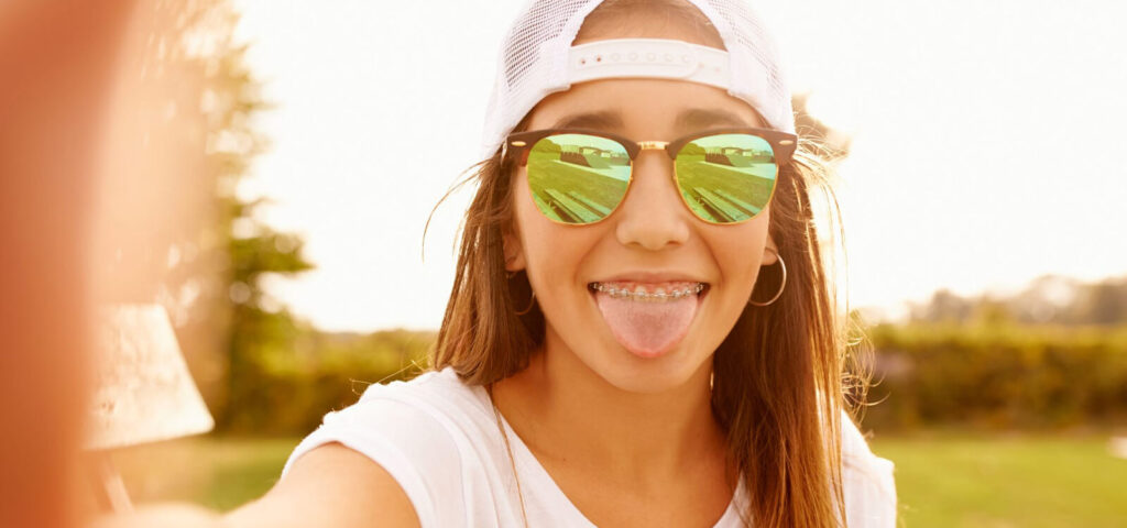 Girl with braces showing her tongue out