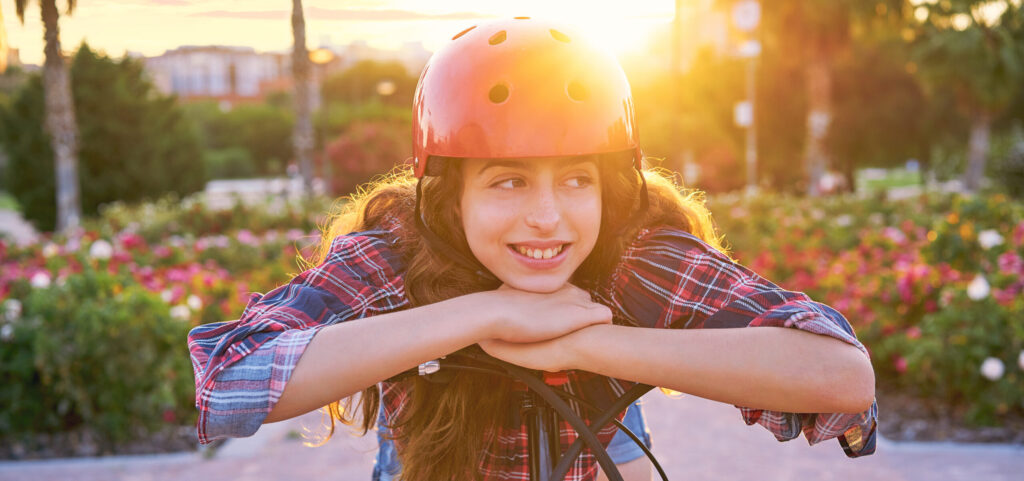 teen rides scooter home after learning braces vs Invisalign pros and cons