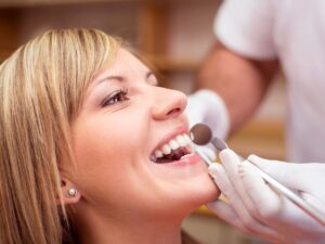 adult at dentist getting her dental cleanings with braces